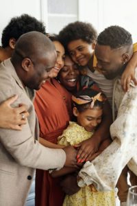 Image of a family of 7 hugging each other. If you want a relationship like this with your loved ones family therapy in Colorado Springs, CO can help. Learn ways to resolve conflict so you can connect from a family therapist in family counseling.