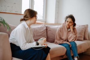 Image of a female meeting with a therapist for teenagers in Colorado Springs, CO. During teen counseling you can discuss what is bothering you with an understanding adult. Find guidance and support in teen therapy in Colorado Springs, CO.