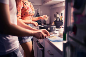 Image of a couple cooking together which is a suggested date night idea from a Colorado Springs couples therapist. If your relationship needs further support couples therapy and couples counseling in Colorado Springs, CO can help. 