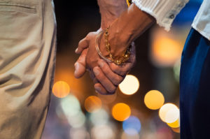 Image of a couple holding hands. Showing the benefits of couples therapy in Colorado Springs, CO. Where you can get more date night ideas from a Colorado Springs couples therapist to strengthen your relationship.
