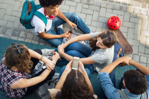 Image of 5 adolescents sitting together. Showing how counseling for teens, or teen therapy, can hep build interpersonal relationships. A therapist for teenagers will help them build stronger connections in Colorado Springs, CO.