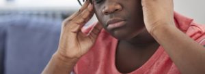 A close-up of a person holding their temples with a concerned expression. This could represent the mental fog that depression treatment in Colorado Springs, CO can help you overcome. Contact a Colorado Springs depression therapist or search for depression symptoms colorado springs, co to learn more. 